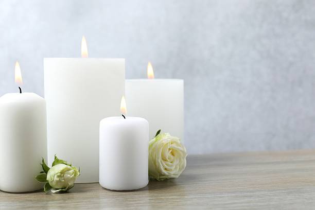 istock White candles on the table with white roses 2250134210
