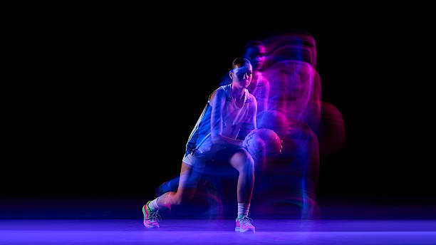 istock Female basketball player training under neon motion lights. 2250135782