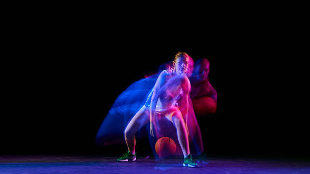 istock Basketball player dribbling low in colorful motion blur lighting. 2250135794