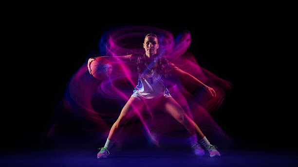 istock Basketball player surrounded by pink and blue energy motion. 2250135806