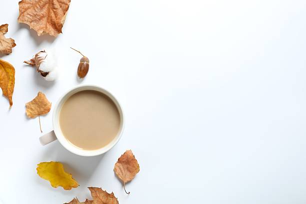 istock Cup of coffee with autumn leaves on a white background 2250135846