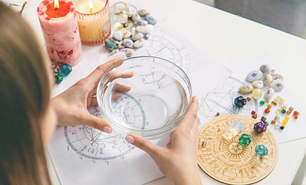 istock Ceromancy wax divination ritual with astrological charts, crystals, and runes on a table 2250136286