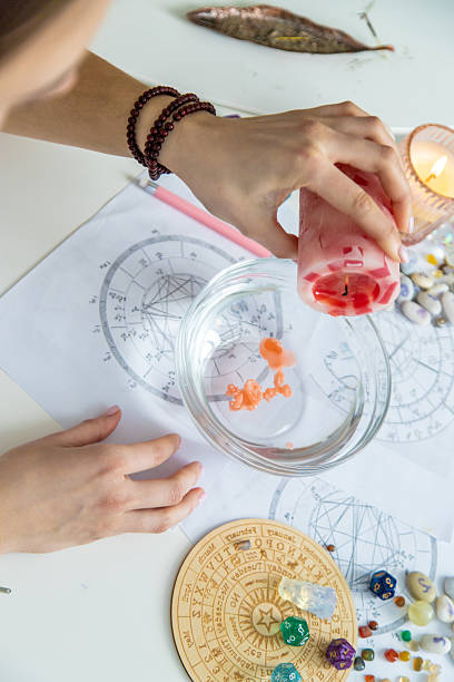istock Ceromancy wax divination ritual with astrological charts, crystals, and runes on a table 2250136302