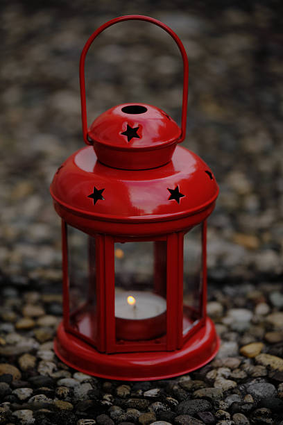 Garden lights in the dark and lanterns in the background.