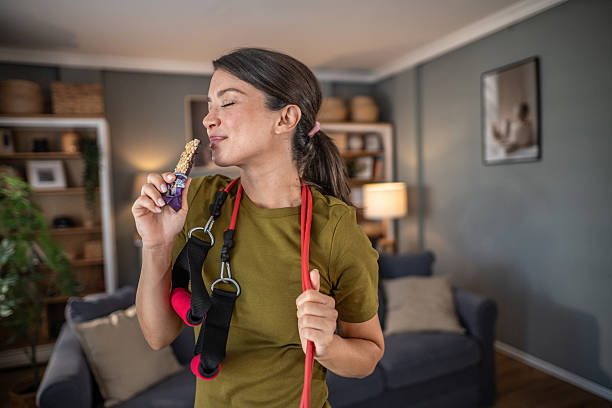 istock Woman enjoying protein bar after home workout 2250138355