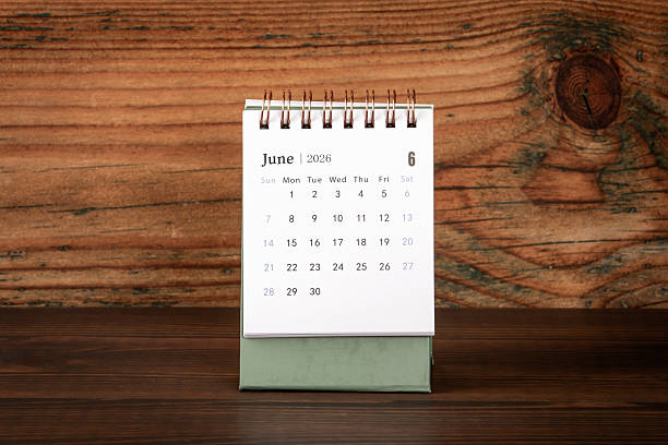 istock June 2026 Desk Calendar on Wooden Workspace Surface 2250138776