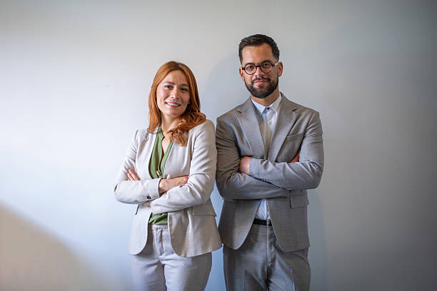 istock Business partners standing with crossed arms smiling at camera 2250142312