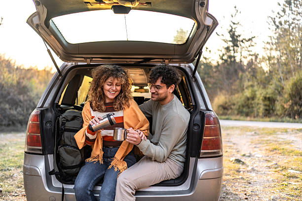 istock Couple enjoying coffee from thermos during road trip 2250142798