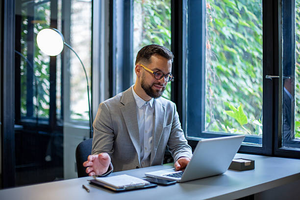 istock Businessman having video conference using laptop in office 2250144706