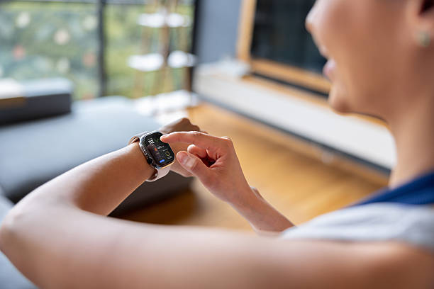 istock Woman training at home and checking her progress on her smart watch 2250144959