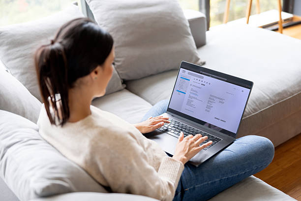 istock Woman at home checking her e-mail on her laptop at home 2250144996