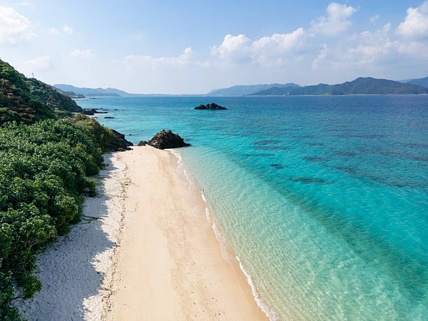 drone point of view on beautiful sakibaru beach in amami oshima island, kagoshima prefecture, northern okinawa islands in japan.