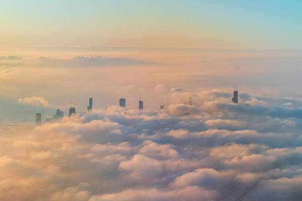 istock Aerial view of Chicago's skyline with skyscrapers emerging through dense cloud cover 2250146249