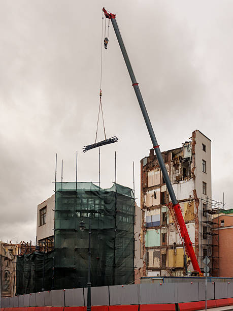 istock large building is being demolished by a large excavator. 2250148276
