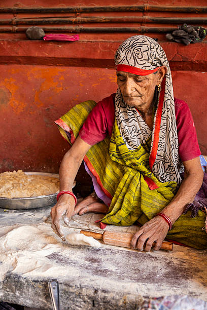 istock Elderly Woman Preparing Roti — Jaipur, India 2250150714