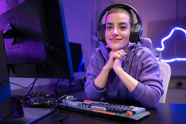 istock A focused gamer sits at a desk and types on a mechanical keyboard in a neon-lit gaming setup 2250153596