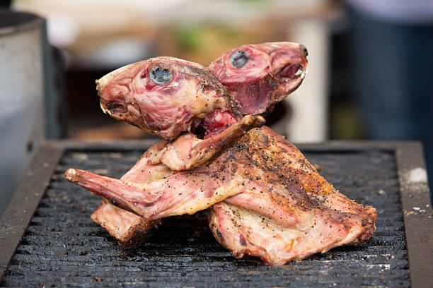 Two rabbits with heads, grilled and ready to be eaten at a barbecue competition