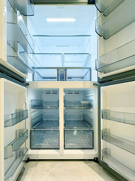 istock Refrigerator in the kitchen. Open and empty double door refrigerator 2250153901
