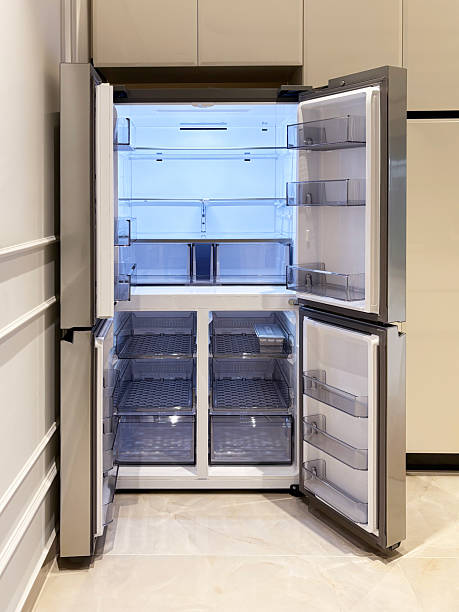 istock Refrigerator in the kitchen. Open and empty double door refrigerator 2250153991