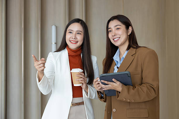 istock Smiling businesswomen chatting during coffee break 2250158928