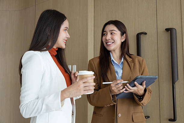 istock Smiling businesswomen chatting during coffee break 2250158979