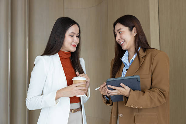 istock Smiling businesswomen chatting during coffee break 2250158996