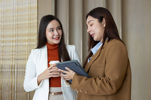 istock Smiling businesswomen chatting during coffee break 2250159012