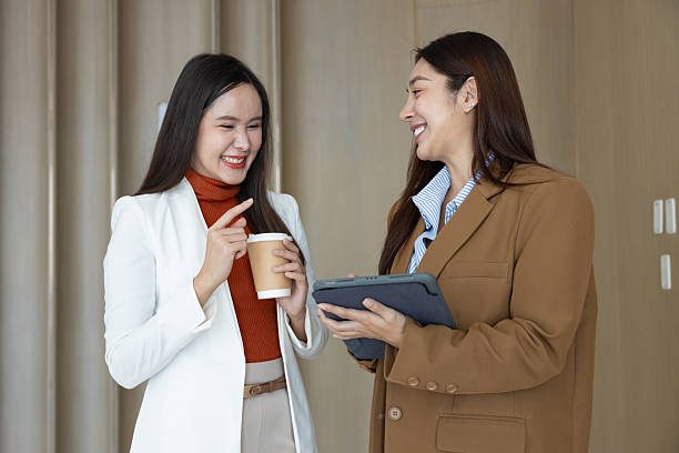 istock Smiling businesswomen chatting during coffee break 2250159044