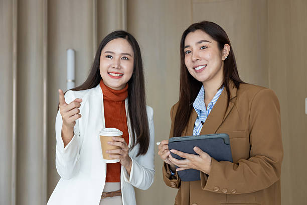 istock Smiling businesswomen chatting during coffee break 2250159054