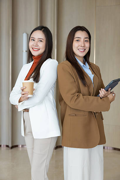 istock Confident businesswomen standing back to back smiling 2250159096