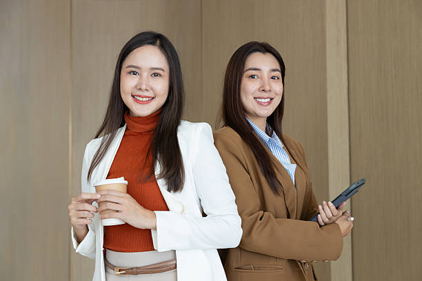 istock Confident businesswomen standing back to back smiling 2250159159