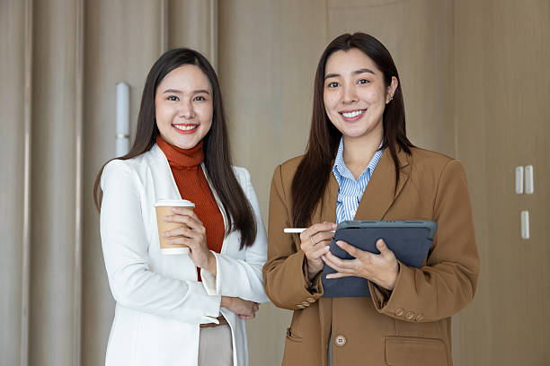 istock Confident businesswomen standing back to back smiling 2250159190