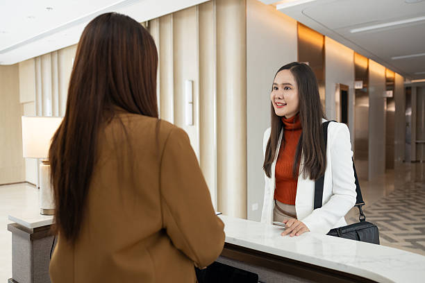 istock Businesswoman checking in at office reception desk 2250159200