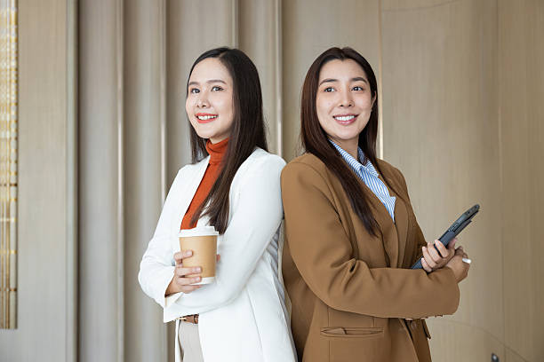 istock Confident businesswomen standing back to back smiling 2250159206