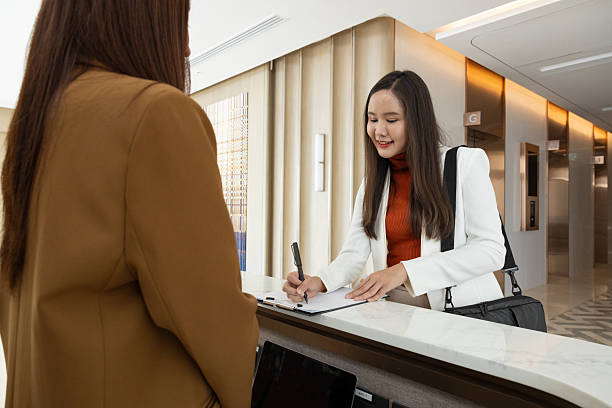 istock Businesswoman checking in at office reception desk 2250159271