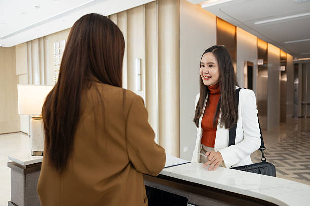 istock Businesswoman checking in at office reception desk 2250159273