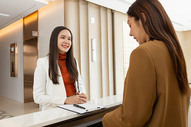 istock Businesswoman checking in at office reception desk 2250159292