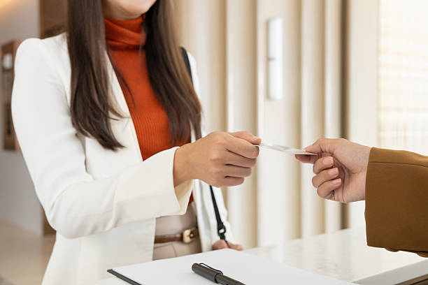 istock Businesswoman checking in at office reception desk 2250159303