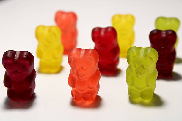 istock Colorful gummy bears in bright colors positioned upright on white surface displaying characteristic bear shape and glossy candy finish 2250160531