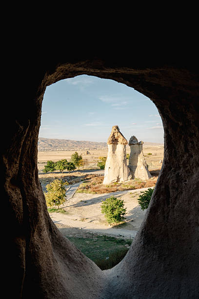 Surreal rock structures of Love Valley seen from within a cave Cappadocia, Turkey.