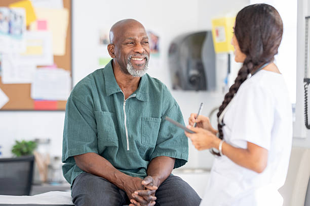 istock Smiling Black Patient Talks With Nurse During Medical Checkup in a Clinic Setting 2250161430
