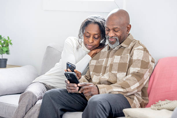 istock Black Couple Relaxing At Home Together, Sharing A Moment While Looking At Phone, Pleasant Afternoon 2250161546
