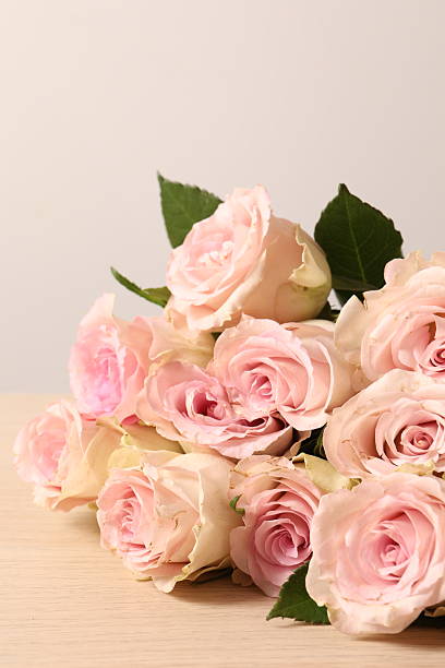 istock Beautiful pink roses on wooden background 2250161625