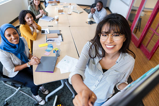 istock Diverse group of professionals collaborating and smiling during a meeting in a modern office setting. 2250161852
