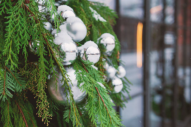 istock Silver baubles on evergreen branches decorates outdoor winter scene 2250163391