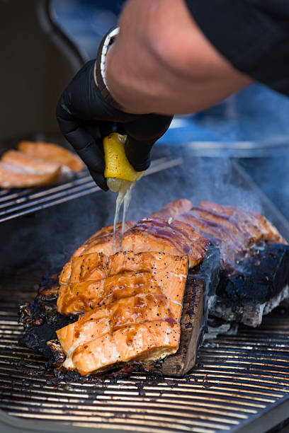 adding lemon juice to the salmon