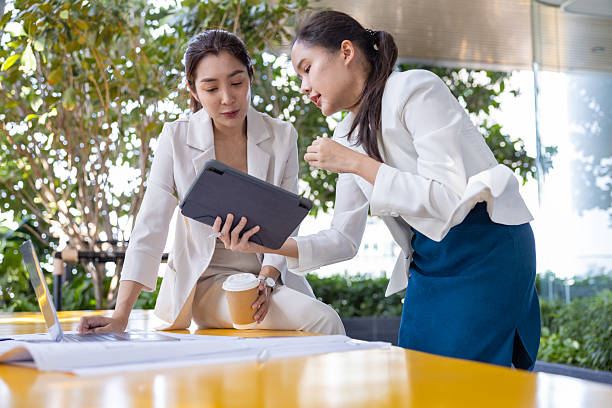 istock Businesswomen collaborating on architecture project outdoors 2250164856