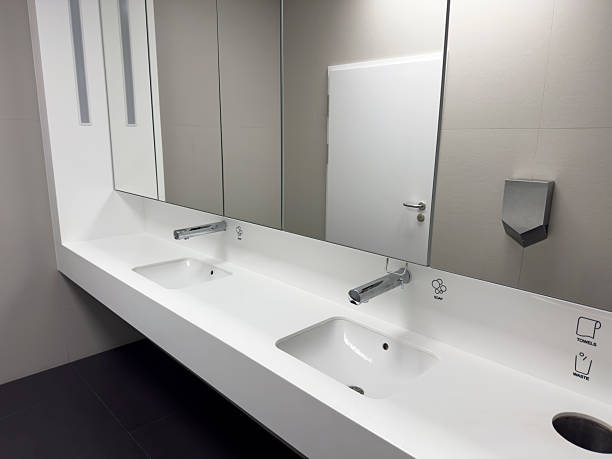 istock Clean, Modern Public Bathroom Sinks and Mirror in Minimalist Style 2250164862