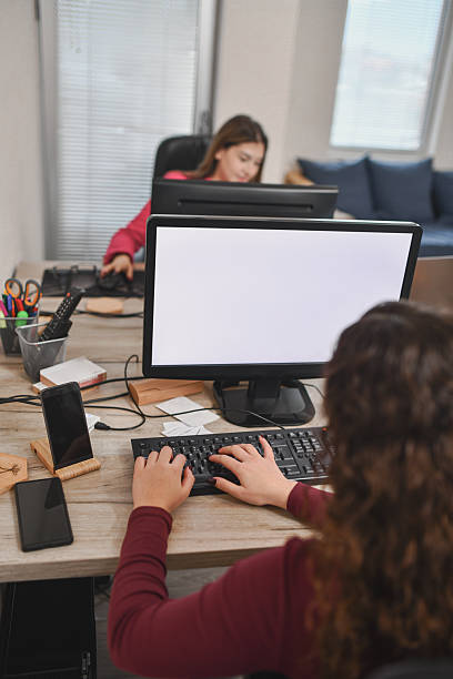 istock Business Professionals Working with Paperwork and Technology in Office Setting 2250164991