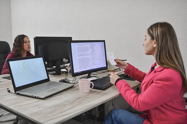 istock Coworkers Discussing and Marking Important Notes During Workday 2250165041